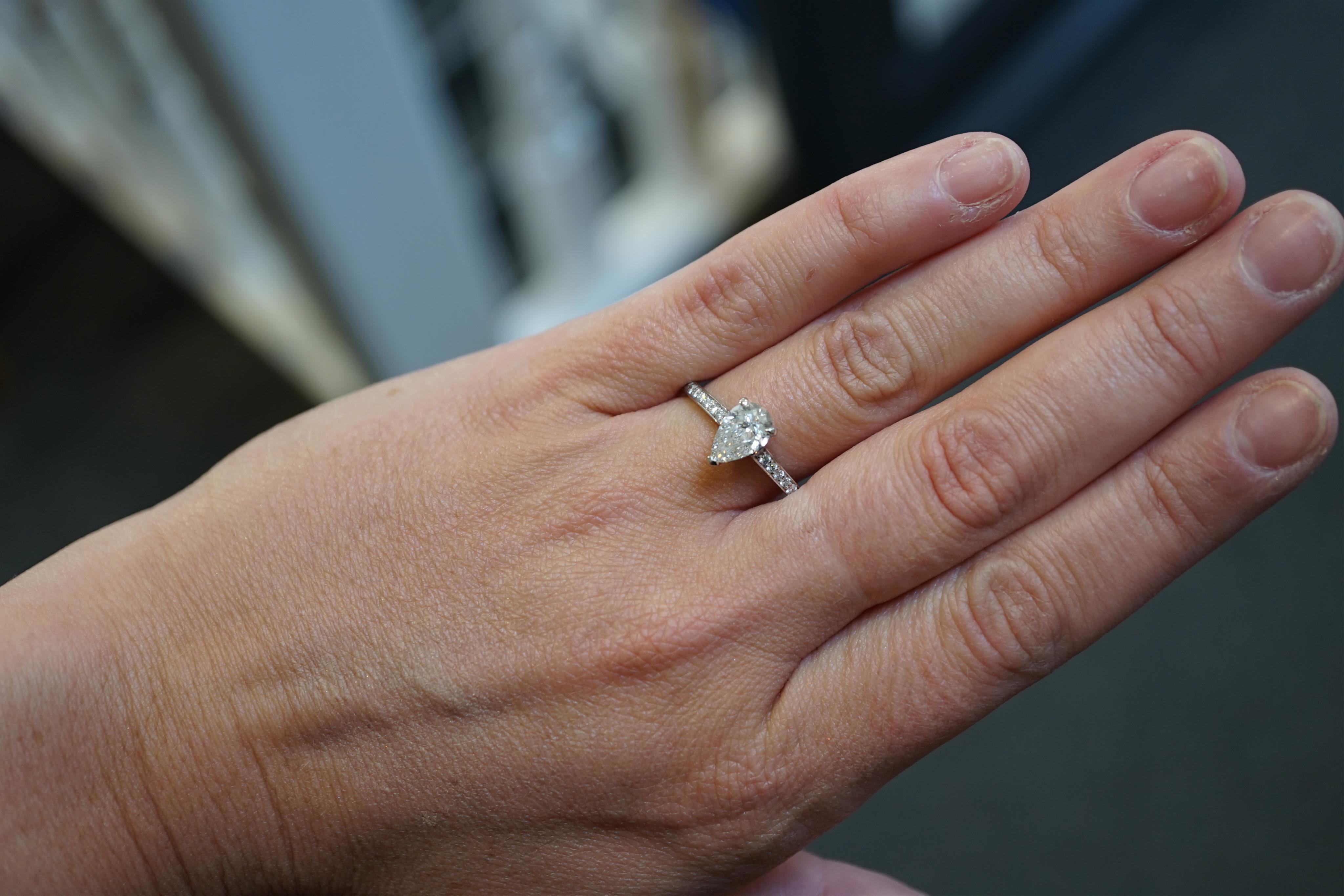 A recent Boodles platinum and single stone pear cut diamond set Harmony design ring, with diamond chip set shoulders and setting